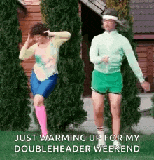 a couple of women are dancing in front of a house and trees .