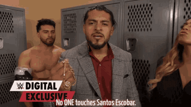 a man in a suit is standing in a locker room with a digital exclusive banner behind him