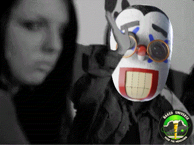 a woman stands next to a clown mask that says " naked unicorn "