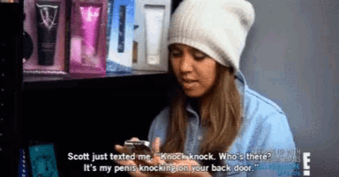a woman wearing a beanie is talking on her phone