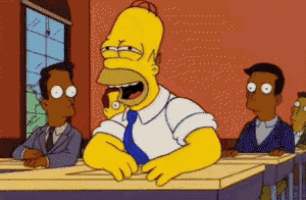 a cartoon of homer simpson sitting at a desk in a classroom