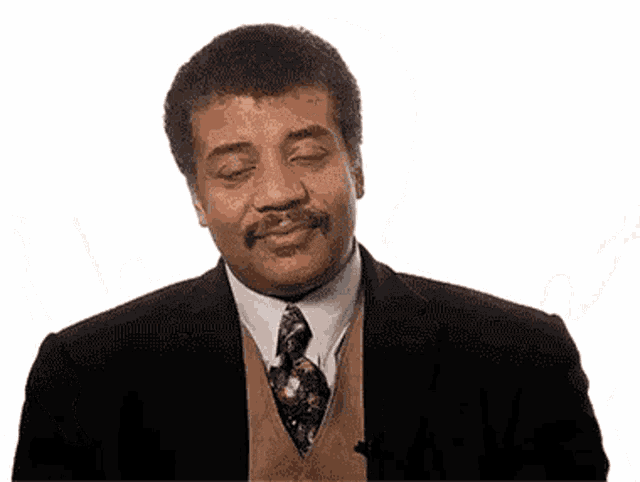 a man in a suit and tie is making a funny face