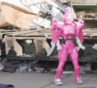 a pink robot is standing in front of a pile of rubble with the number 202 on it