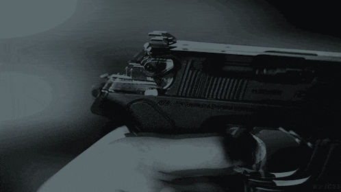 a black and white photo of a person holding a gun with a watermark that says wu-zhang