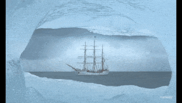 a picture of a ship in the ocean is taken through a hole in the ice