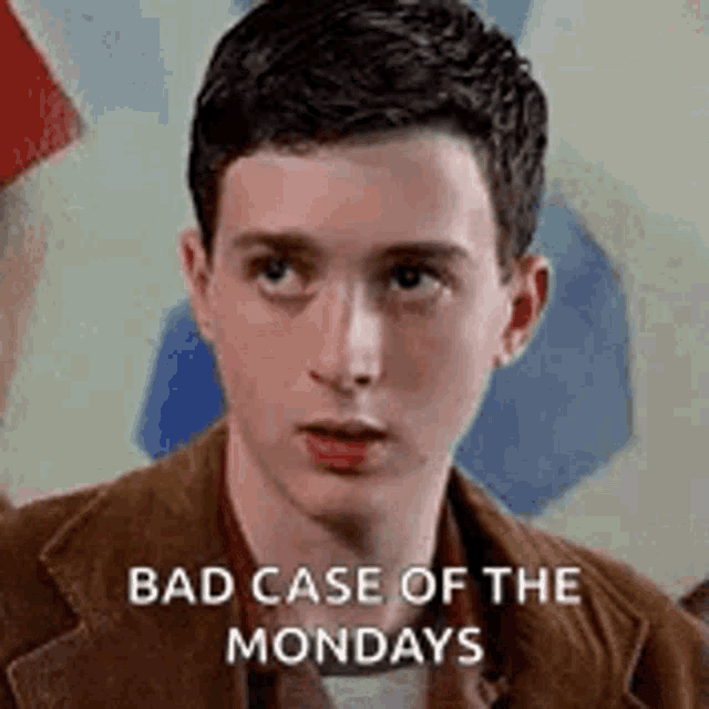 a young man in a suit is looking at the camera with the words `` bad case of the mondays '' written on his face .