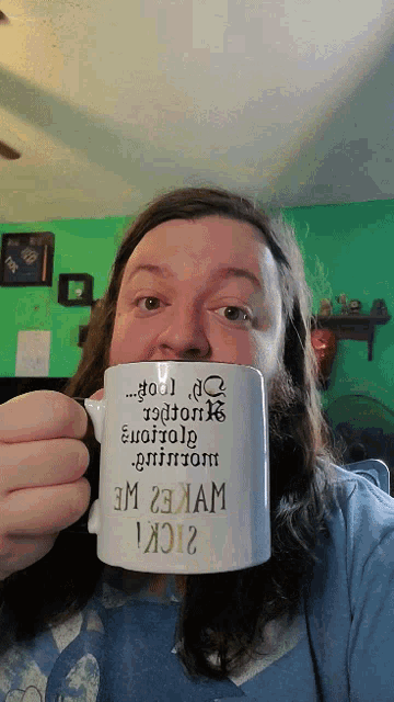 a man with a beard is holding a mug that says fool