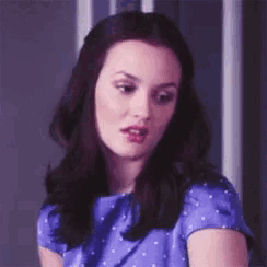a close up of a woman 's face wearing a blue shirt .