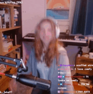 a woman holding a microphone in front of a keyboard