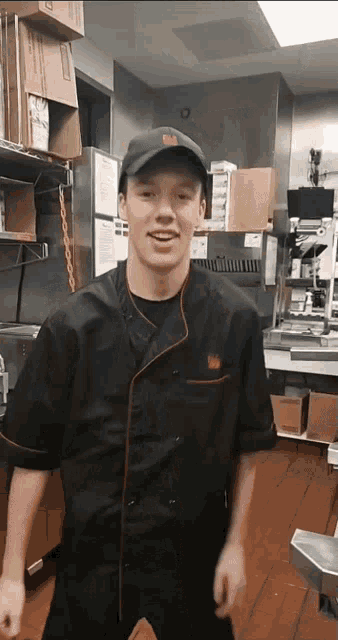 a man wearing a chef 's uniform and a hat that says ' tgi friday ' on it