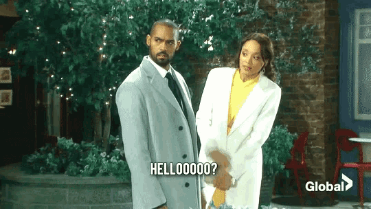 a man and a woman are standing next to each other and the man is saying hello000