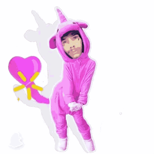 a man is wearing a pink unicorn costume with a heart in the background .