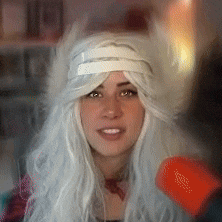 a woman wearing a white wig and a furry hat