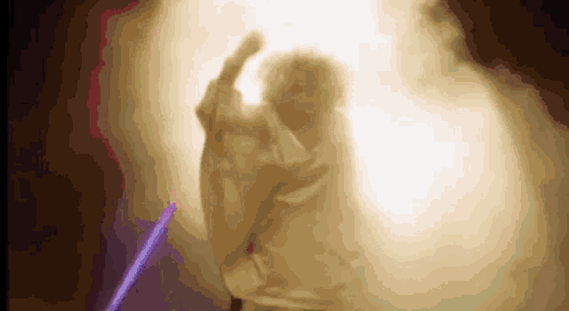 a blurred image of a person holding a light sword