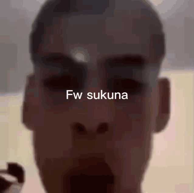 a close up of a person 's face with the words fw sukuna written on it