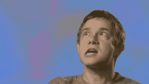 a man is making a funny face while looking up at something .