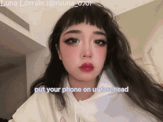 a picture of a girl with the words put your phone on ur forehead