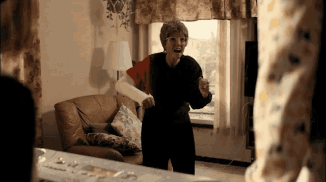 an elderly woman with a broken arm is standing in a living room