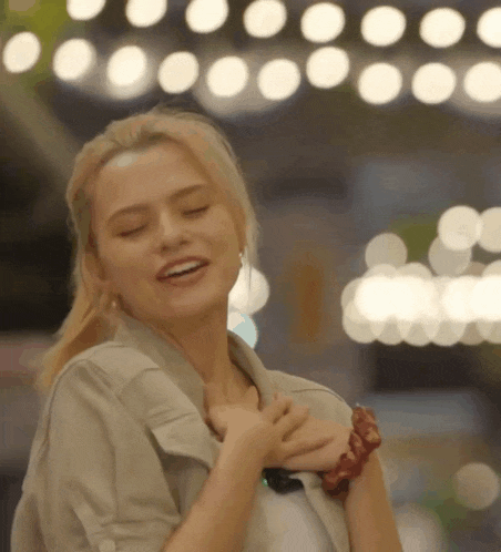 a woman with her eyes closed is wearing a scrunchie