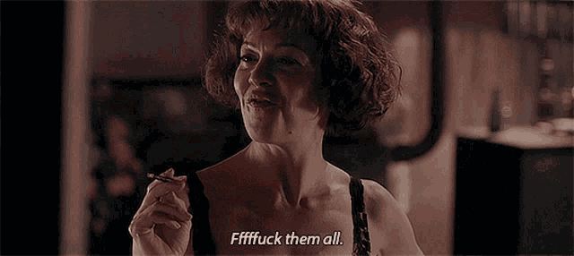 a woman is smoking a cigarette and says " fffffuck them all "