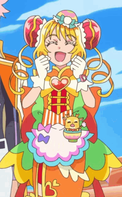a girl in a colorful dress with a heart on her chest is smiling