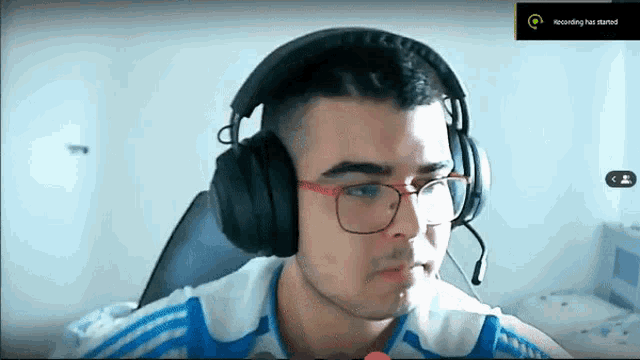 a man wearing headphones and glasses is on a video call and recording has started