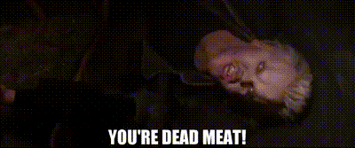 a man is laying on his back with the words `` you 're dead meat '' written on the bottom .