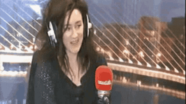 a woman wearing headphones and holding a microphone that says smarttalk on it