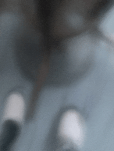 a blurry picture of a person 's feet with white shoes on