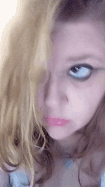 a close up of a woman 's face with a pink lip