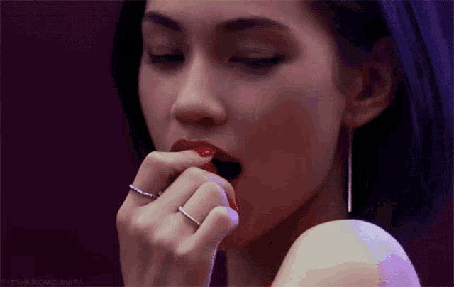 a close up of a woman 's face with a purple background that says yeahkimzuhara on it