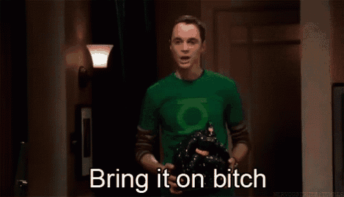 a man wearing a green lantern shirt is holding a black bag and saying bring it on bitch .