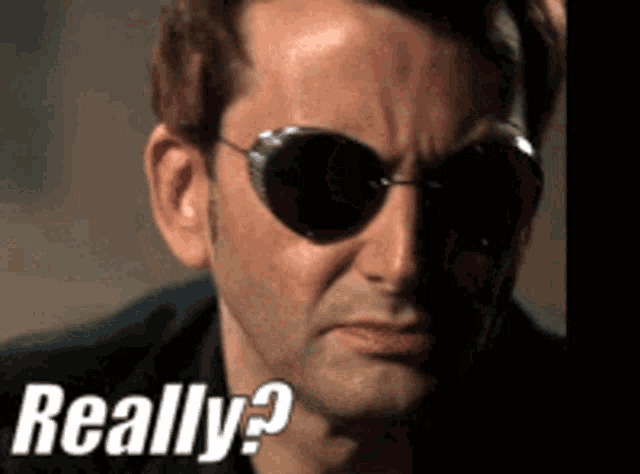 a close up of a man wearing sunglasses and the words really