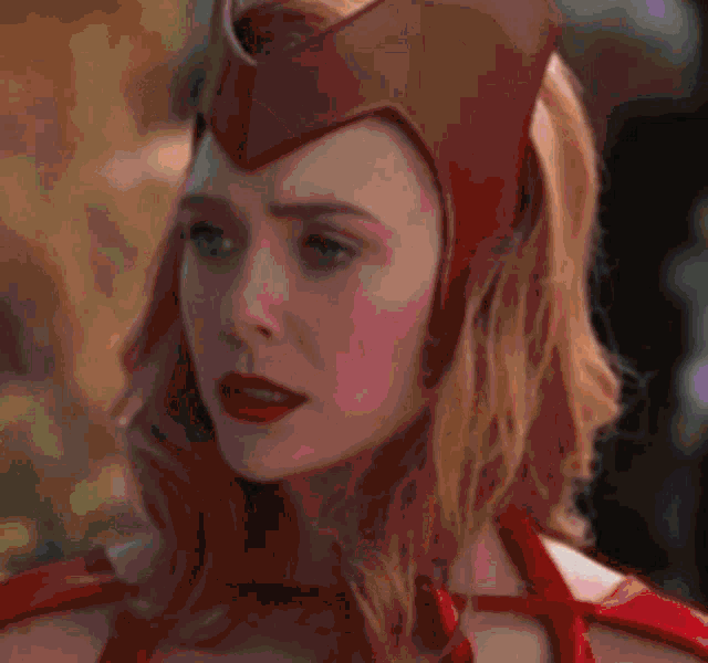 a woman with blonde hair and blue eyes is looking at the camera