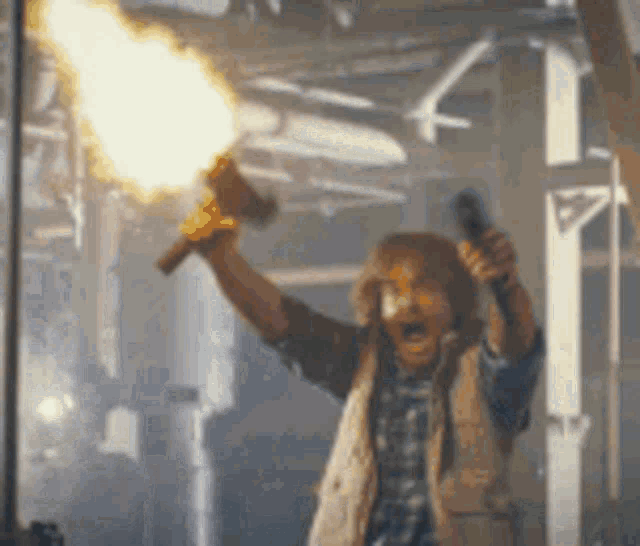 a man is holding a torch that is on fire .