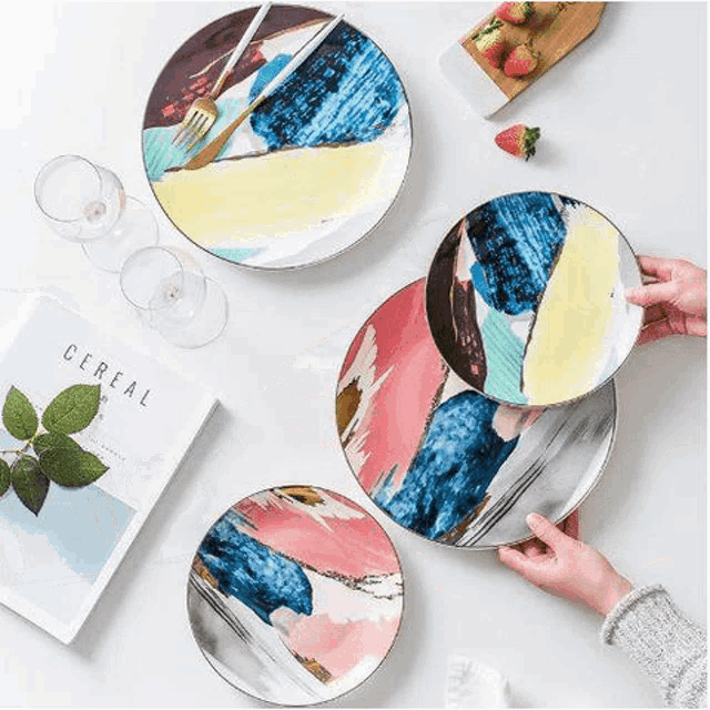 a person is holding a plate with a fork on it .