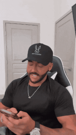 a man wearing a black hat with a bunny logo on it