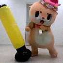 a stuffed animal wearing a pink hat is standing next to a yellow bat .