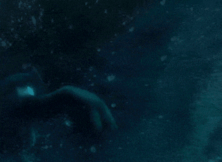 a close up of a blue light coming out of a hole in the dark .