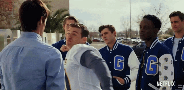 a group of young men wearing varsity jackets with the letters gg on them