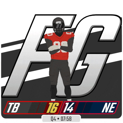 a football player is standing in front of a large tb logo
