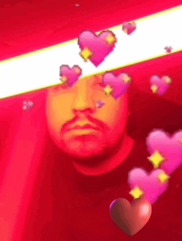 a man 's face is surrounded by pink hearts