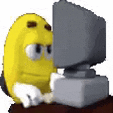 a cartoon character is sitting in front of a computer monitor .