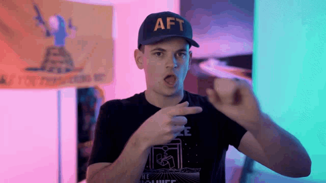 a man wearing a hat that says aft makes a funny face