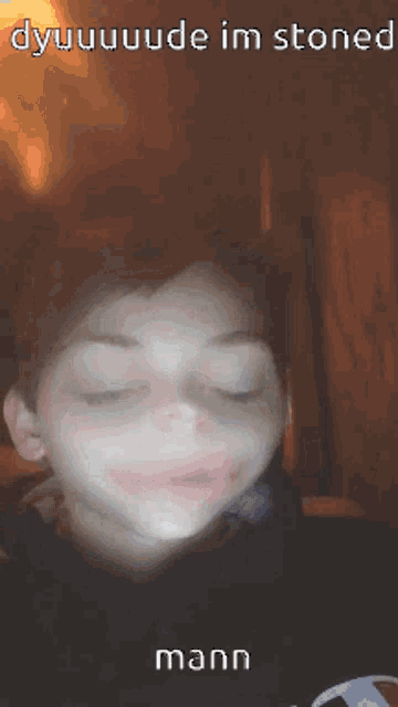 a person with their eyes closed and the word mann on the bottom right