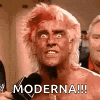 a man with a mohawk is talking into a microphone and saying `` moderna ! ''