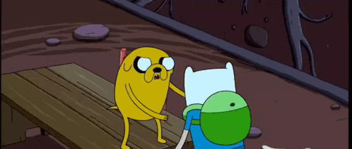 a cartoon character named jake is standing next to finn