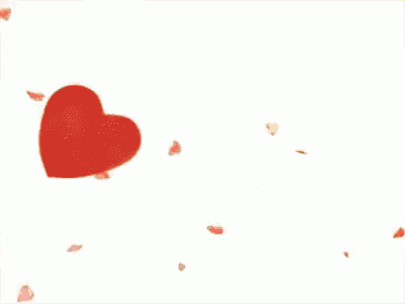 a teddy bear is sitting in front of a pile of red hearts .