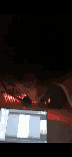 a blurry picture of a person looking at a laptop
