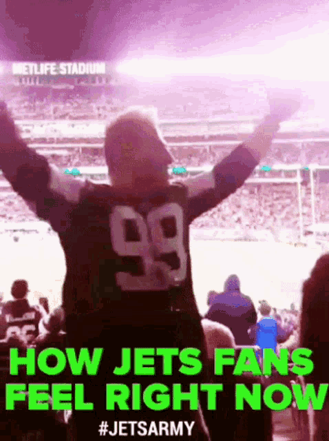 a man wearing a number 99 jersey stands in a stadium